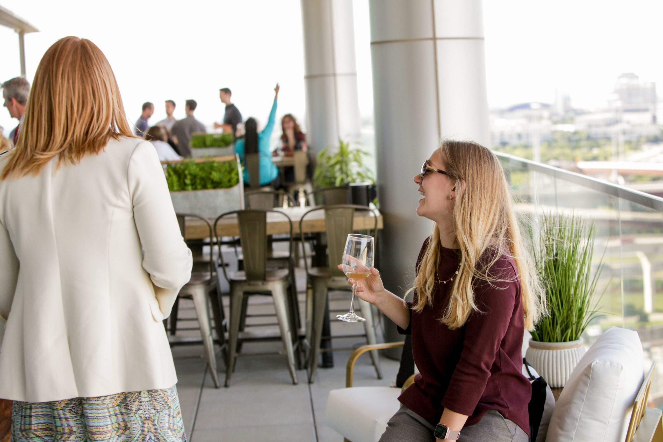 Colleagues and clients enjoy drinks on the Lifeblue balcony during the official grand opening for the new office.